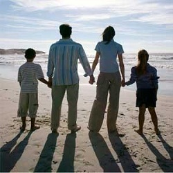 Family holding hands on the beach