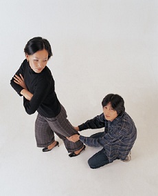 Man holding onto woman's leg
