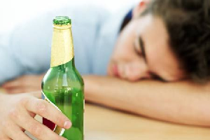 Man passed out with beer bottle in hand