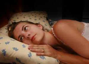 Awake woman lying in bed