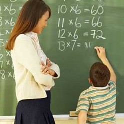 Child doing multiplication on chalkboard