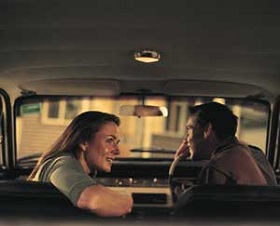 Woman in car with man talking