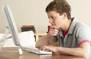 Teen boy using computer