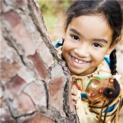 Close up of girl's face leaning her head on a wall