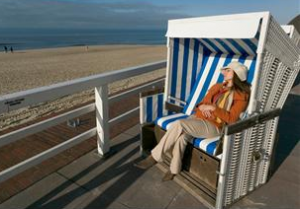 Woman sitting on bench near beach