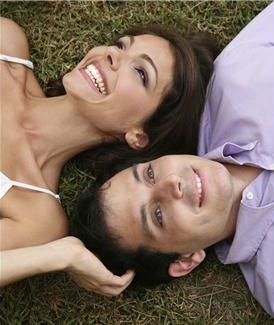 Happy couple lying in grass