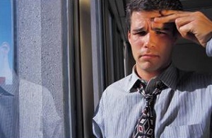 Man with hand to forehead