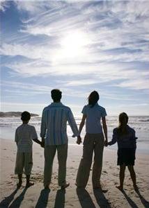 Family standing together on beach