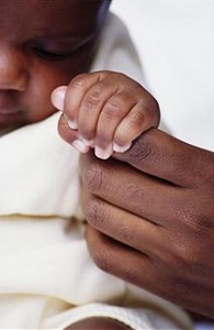 Infant holding mother's finger