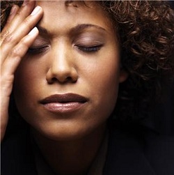 Stressed woman with hand to forehead