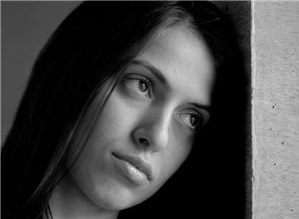 Sad woman leaning head on wall