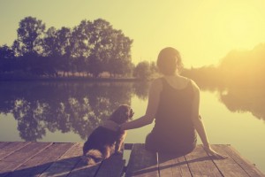 Vintage photo of young woman relaxing with her dog