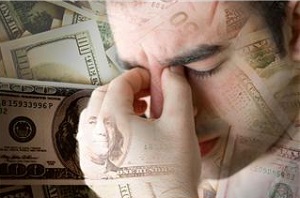 Man with headache and money in background