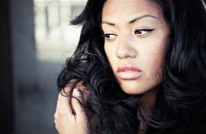 Unhappy woman hugging self
