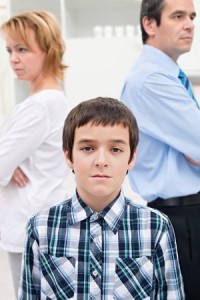 Apathetic boy standing in front of parents refusing to talk