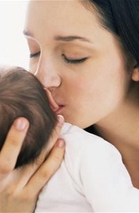 Mother kissing infant