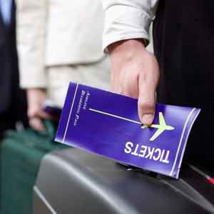 A close-up shows a man's hand holding a travel ticket while waiting in line.