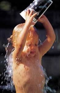 Child pouring water on herself