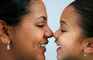 Mother and daughter bumping noses