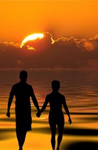 Silhouette of couple on beach at sunset