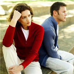 Unhappy couple sitting on stone steps