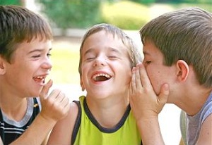 Boys whispering and laughing