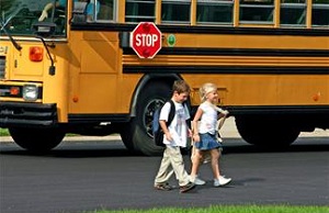 Kids walking in front of school bus