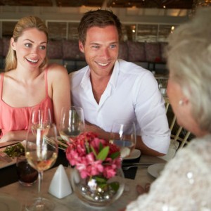 A young couple listens as an older woman talks.