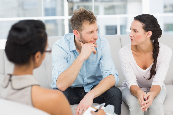 A couple in therapy look at one another