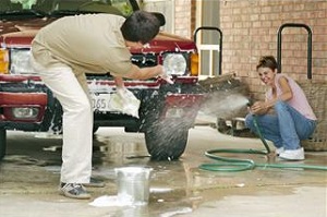 Couple washing car
