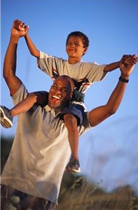 Son riding on father's shoulders