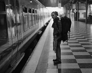 Woman with backpack waiting for train