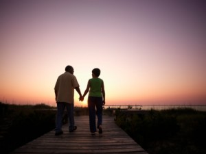 Couple walking down wood path