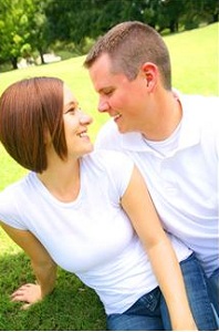 Couple sitting together in grass