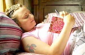 Sleeping woman holding journal