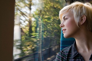 Woman looking out train window