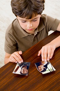 Boy with ripped photo of parents