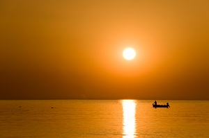 Canoe in open water near sunset
