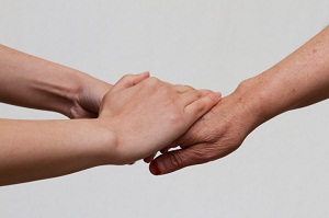 Hands holding older hand