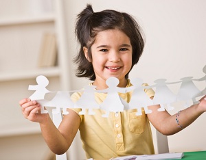 Smiling girl with paper people