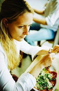Woman eating salad