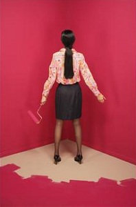 Woman painting herself into a corner