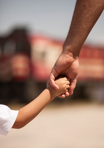 arms-of-man-and-child-holding-hands