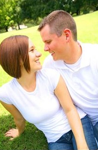 Couple sitting together in grass