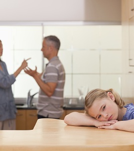Unhappy child and fighting parents in kitchen