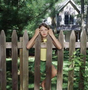 Girl leaning on fence
