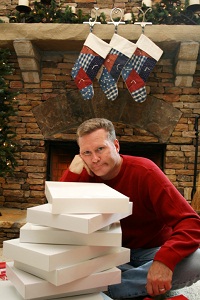 Man with stack of unwrapped gifts