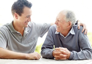 Old man and younger man laughing