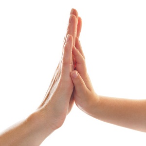 Parent and child touching palms