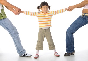 Parents pulling child in opposite directions